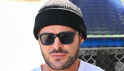 Bearded Zac Efron shows off his buff physique in a tight white T-shirt