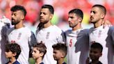 Iran players sing national anthem while fans jeer before Wales World Cup match