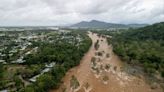 Desperate Australians risk wading through crocodile-infested floodwater to get to safety