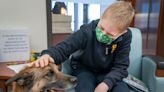 Children with cancer read to police dogs at Royal Oak hospital