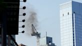 Pedestrians scatter as fire causes New York construction crane's arm to collapse and crash to street