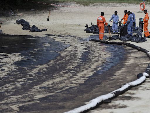 Singapore rushes to clean up oil slick after boat hits stationary fuel supply ship