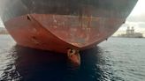 African migrants on rudder of a ship rescued by Spanish coast guard after an 11-day voyage