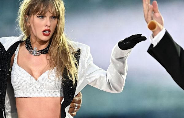 Travis Kelce Joins Taylor Swift Onstage for Surprise Appearance at Eras Tour Show - E! Online