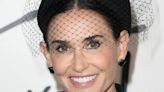 Demi Moore does Venetian carnival vibes in purple gown and masquerade mask