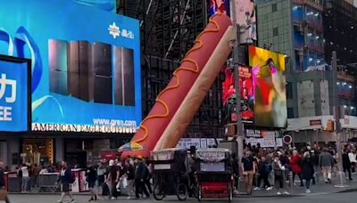 Why is there a giant hot dog art installation in Times Square?