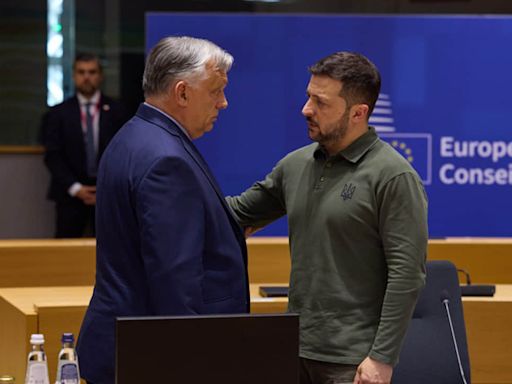 Orbán and Zelenskyy have charged conversation on sidelines of EU summit after shaking hands – video