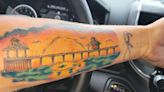 Fort Myers Beach pier tattoo with sunset etched on woman's arm is a masterpiece