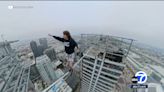 Daredevil seen on video walk tightrope between graffitied skyscrapers in downtown LA
