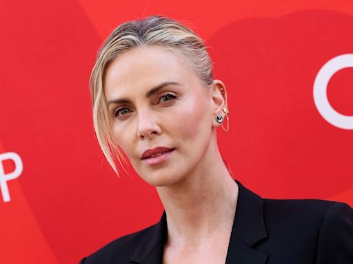 Charlize Theron steps out in a daring black bra and blazer combo as she hosts star-studded affair — photos