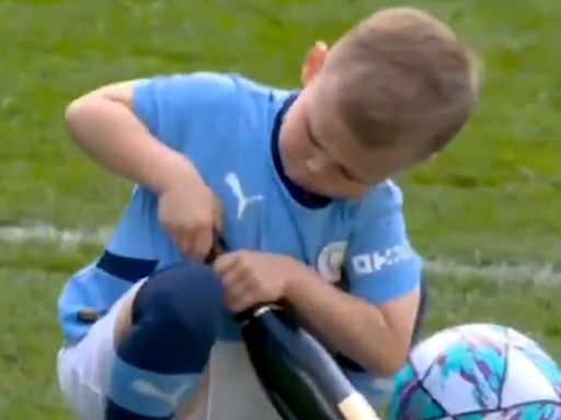 Phil Foden’s five-year-old son spotted trying to open champagne bottle after Manchester City win Premier League