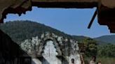 Christian villagers walk through a destroyed Roman Catholic Church in Kandhamal district of India's Odisha state