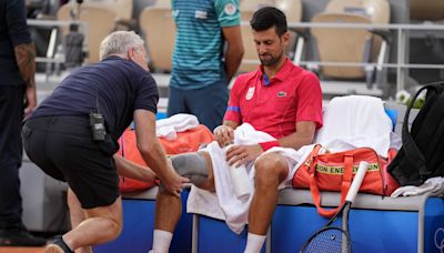 Novak Djokovic's knee injury bothers him at the Paris Olympics but he beats Stefanos Tsitsipas