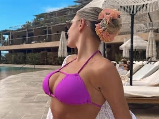 Zara McDermott flashes her taut abs in a skimpy purple bikini as she posts a slew of throwback snaps on Instagram