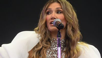 Delta Goodrem's fashion regret sees her carried to stage at festival