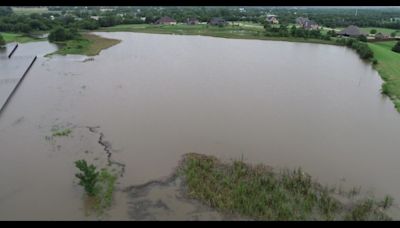 Saturated land leads to erosion concerns at a dam in Rockwall County