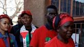 Leftist radical Julius Malema, leader of the Economic Freedom Fighters (EFF), and his wife Mantwa Matlala (2nd L) queued with ordinary voters for four hours before casting their votes