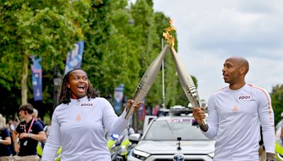 France's Thierry Henry and Romane Dicko carry Olympic flame through Paris on Bastille Day, calling the experience "extraordinary"