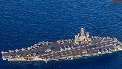 The US Navy carrier strike group fighting off Houthi missiles is staying in the Red Sea for now