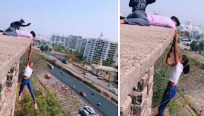 Pune girl hangs from top of building in dangerous stunt. Viral video sparks outrage: ‘Heights of stupidity’