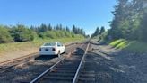 Abandoned car left on railroad tracks in Olympia