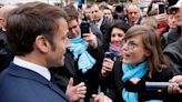 Angry crowd heckles France's Macron over pensions legislation