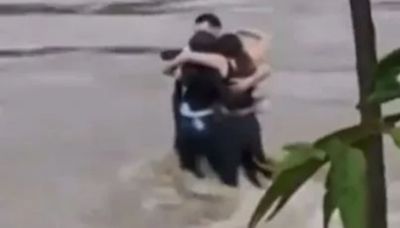 Harrowing moment pals embrace before being swept away by flash floods