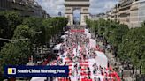 Paris’ Champs-Elysees turned into a mass picnic blanket for an unusual meal