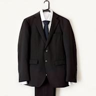 A formal suit worn by men and women in professional settings Typically includes a jacket and trousers or skirt Colors are usually conservative, such as black, navy, or gray Materials may include wool, cotton, or synthetic blends