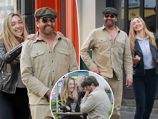 Gerard Butler, 54, all smiles as he cozies up to Sports Illustrated model, 29, during stroll in London