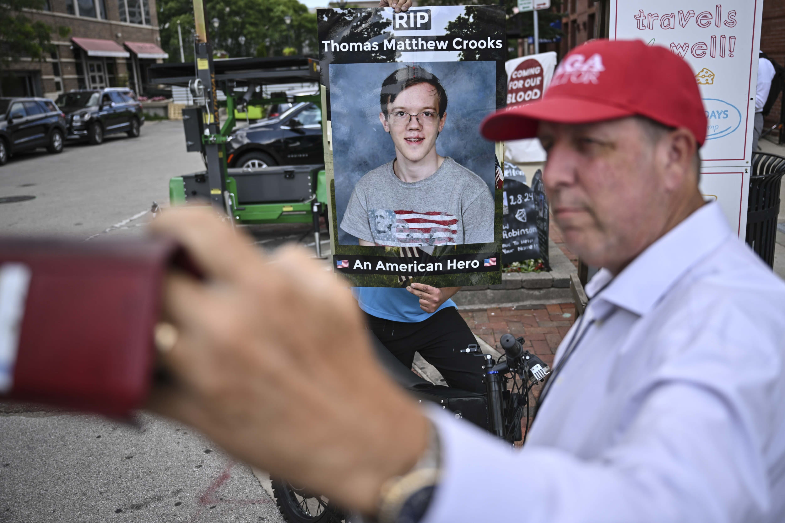 Armed person stands outside RNC with poster calling Thomas Crooks a 'hero'