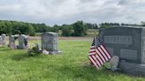 Volunteers place flags at graves of veterans ahead of Memorial Day
