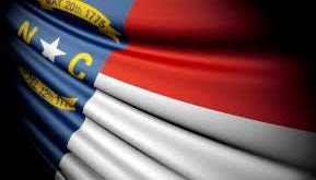 Why are flags flying at half-staff in North Carolina?