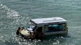 Beachgoers haul abandoned ice cream van from sea in Cornwall