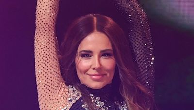 Cheryl holds son Bear's hand as she takes him onstage for first time