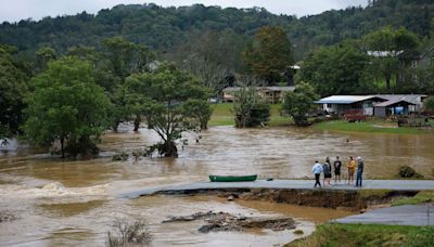 Pregnant mum of two is 'completely trapped' in floods