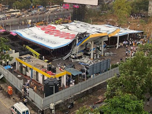 Four dead, several feared trapped as billboard falls over during Mumbai rainstorm | CNN