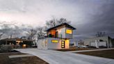 This Modern 2-Story Tiny House Has a Spiral Staircase That Leads to the Balcony