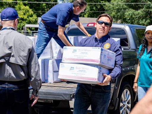 Florida Gov. DeSantis visits Tallahassee school to help distribute supplies after storm