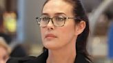 Megan Gale looks stunning in glasses and business suit at the airport