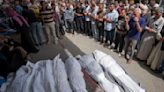 An airstrike kills 20 in central Gaza and fighting rages as Israel's leaders air wartime divisions