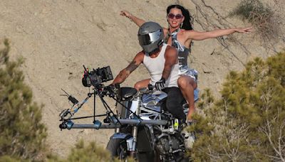 Katy Perry rides pillion on a motorbike while shooting her new video