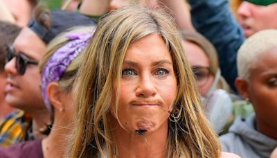 Jennifer Aniston looks FURIOUS when oil is thrown on her