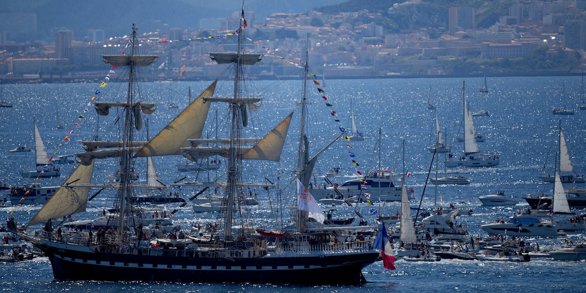 A ship carrying the Olympic torch arrives in Marseille amid fanfare and high security