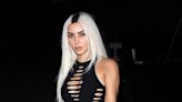 Kim Kardashian flashes the flesh in a shredded black catsuit in LA