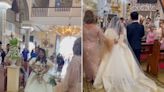 A couple's wedding was struck by a typhoon that flooded their church, so they got married ankle-deep in rainwater anyway