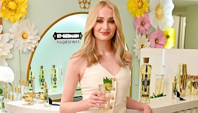 Sophie Turner looks slender in an ivory suit during cocktail event