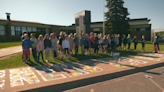 Lakeview Elementary school students paint mural on school sidewalk