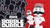 Mr. Redlegs holds bobblehead of himself in FOCO's Bobble Dubblz mascot collectible