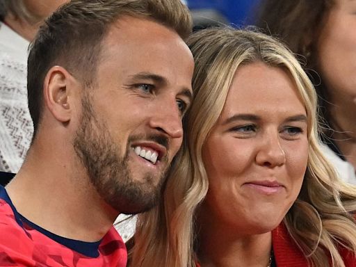 Harry Kane cuddles his wife after a nervy win over Serbia